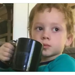 Skeptical Kid with Mug PNG Sticker