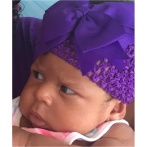 Adorable Baby with Purple Bow